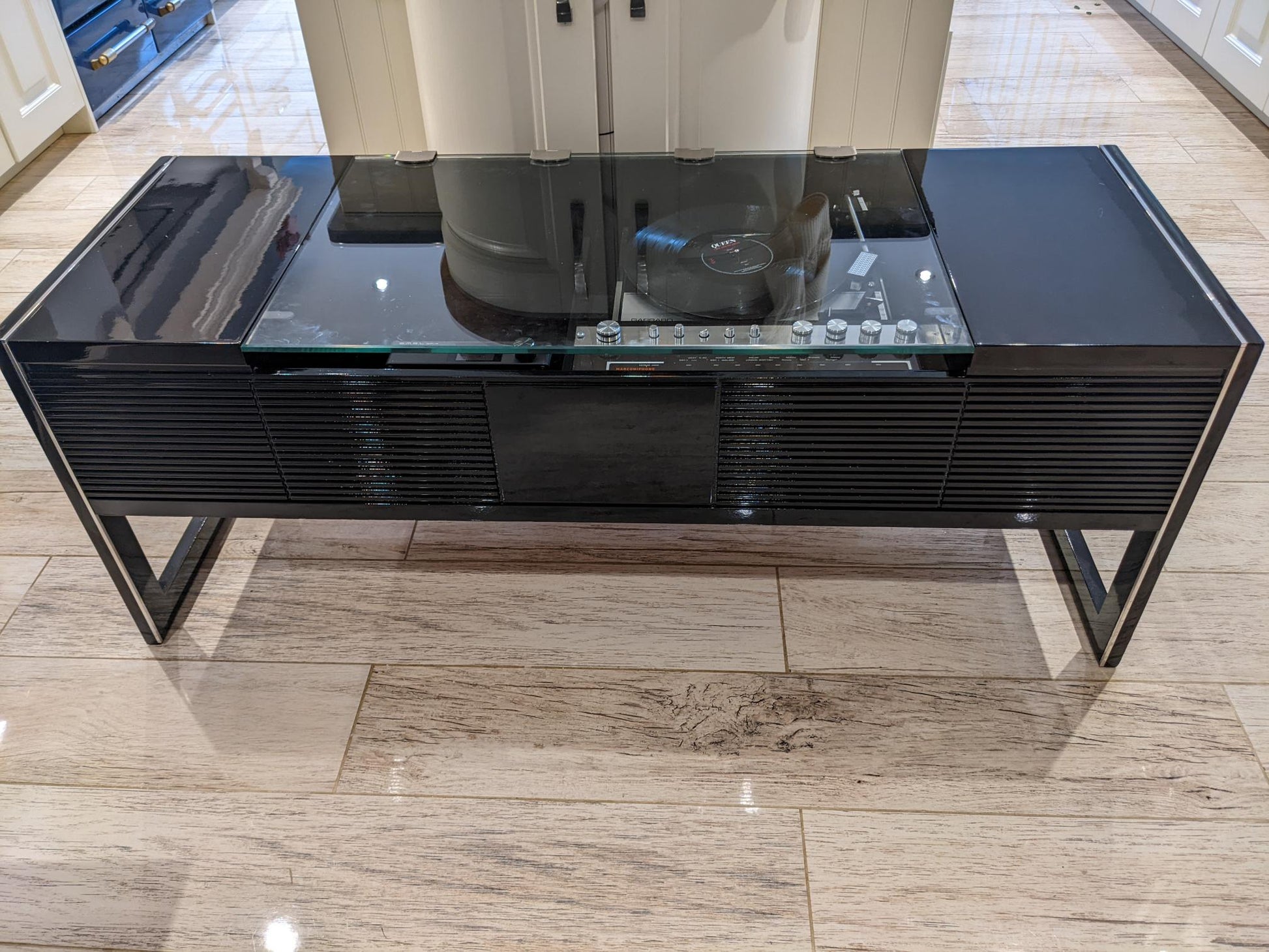 A black coffee table with a built-in Ipod and Bluetooth music system, featuring a turntable on the top.